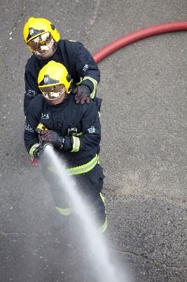 Fire fighters with hose and water